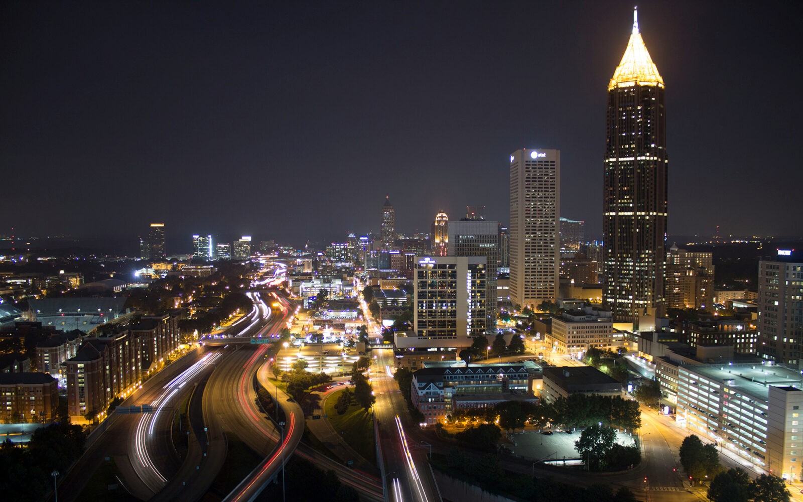 bg-atlanta2 CloudMasonry - Georgia Based Salesforce Consulting - Atlanta Office Landing Page Image - Atlanta skyline at night with illuminated buildings.
