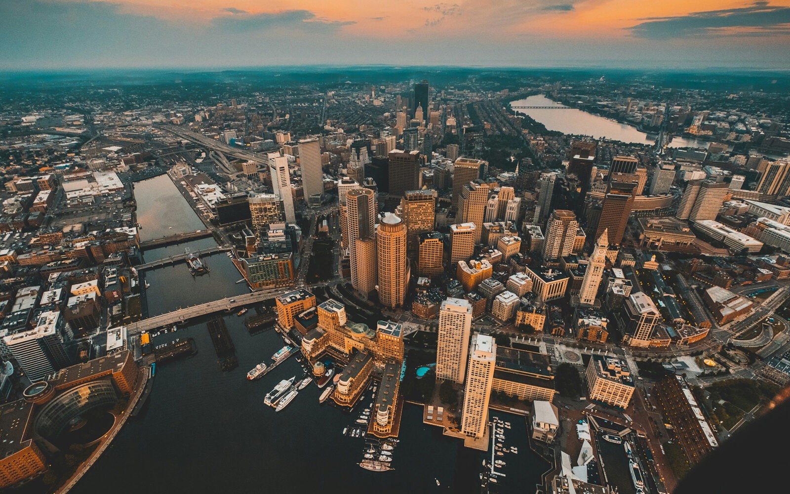 bg-boston2 CloudMasonry - Massachusetts Based Salesforce Consulting - Boston Office Landing Page Image - Aerial view of city skyline at sunset.