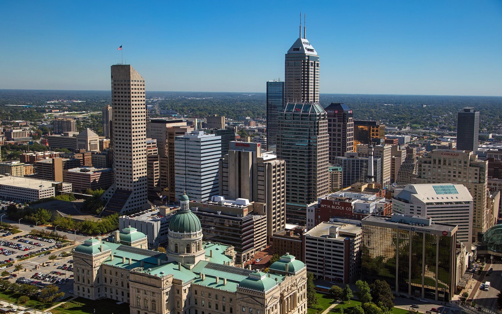 bg-indianapolis2 CloudMasonry - Indiana Based Salesforce Consulting - Indianapolis Salesforce Tower Corporate Headquarters Landing Page Image -Indianapolis skyline with tall buildings and green domes.